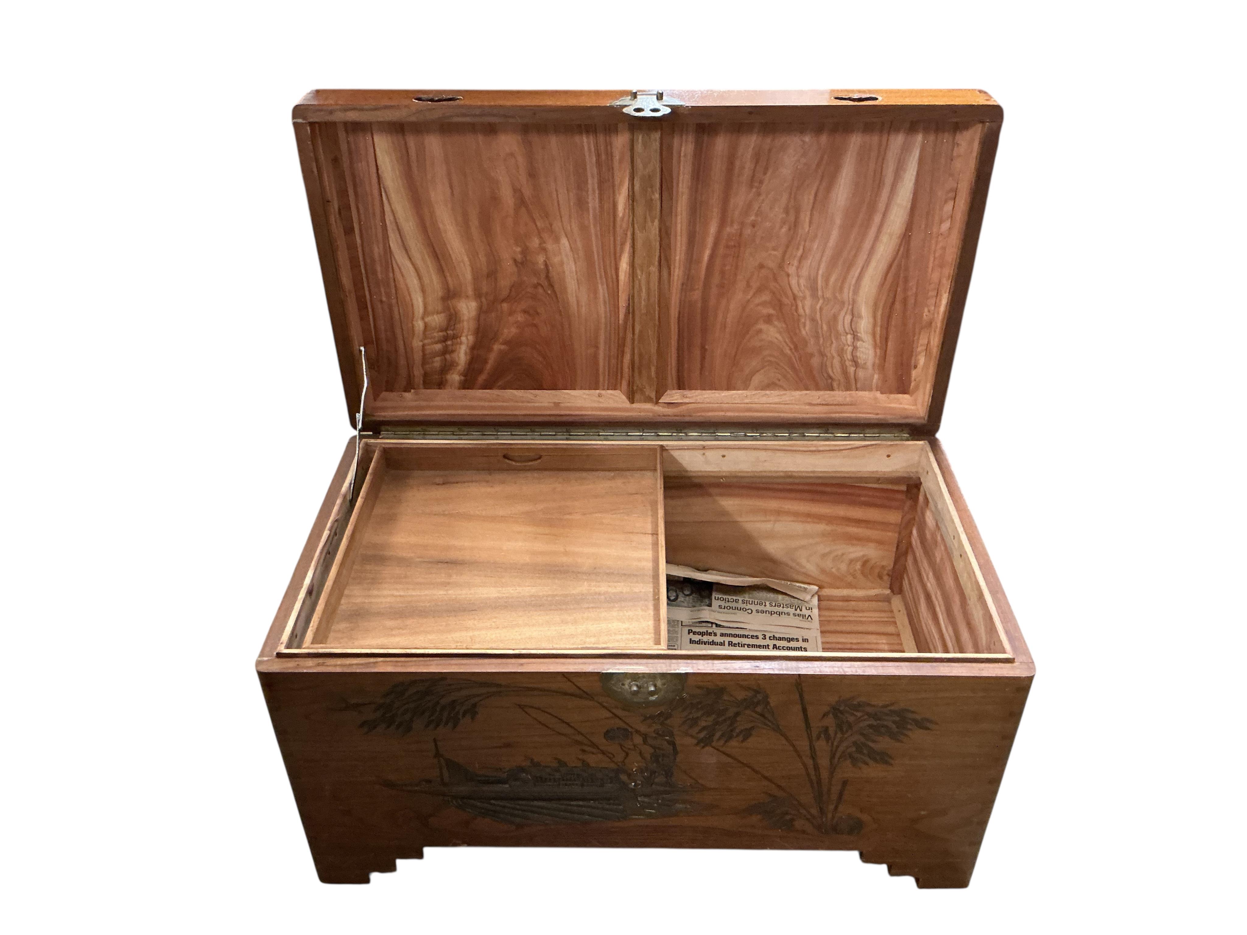 A Chinese carved camphorwood chest, width 100cm, depth 55cm, height 57cm